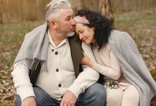 happy senior couple hugging in autumn park